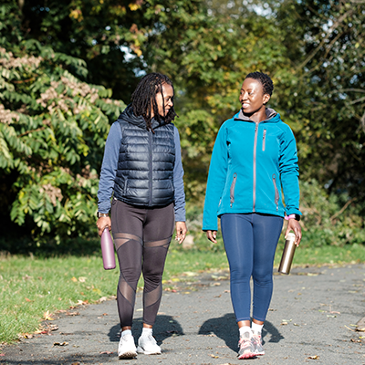 Two people walking outdoors