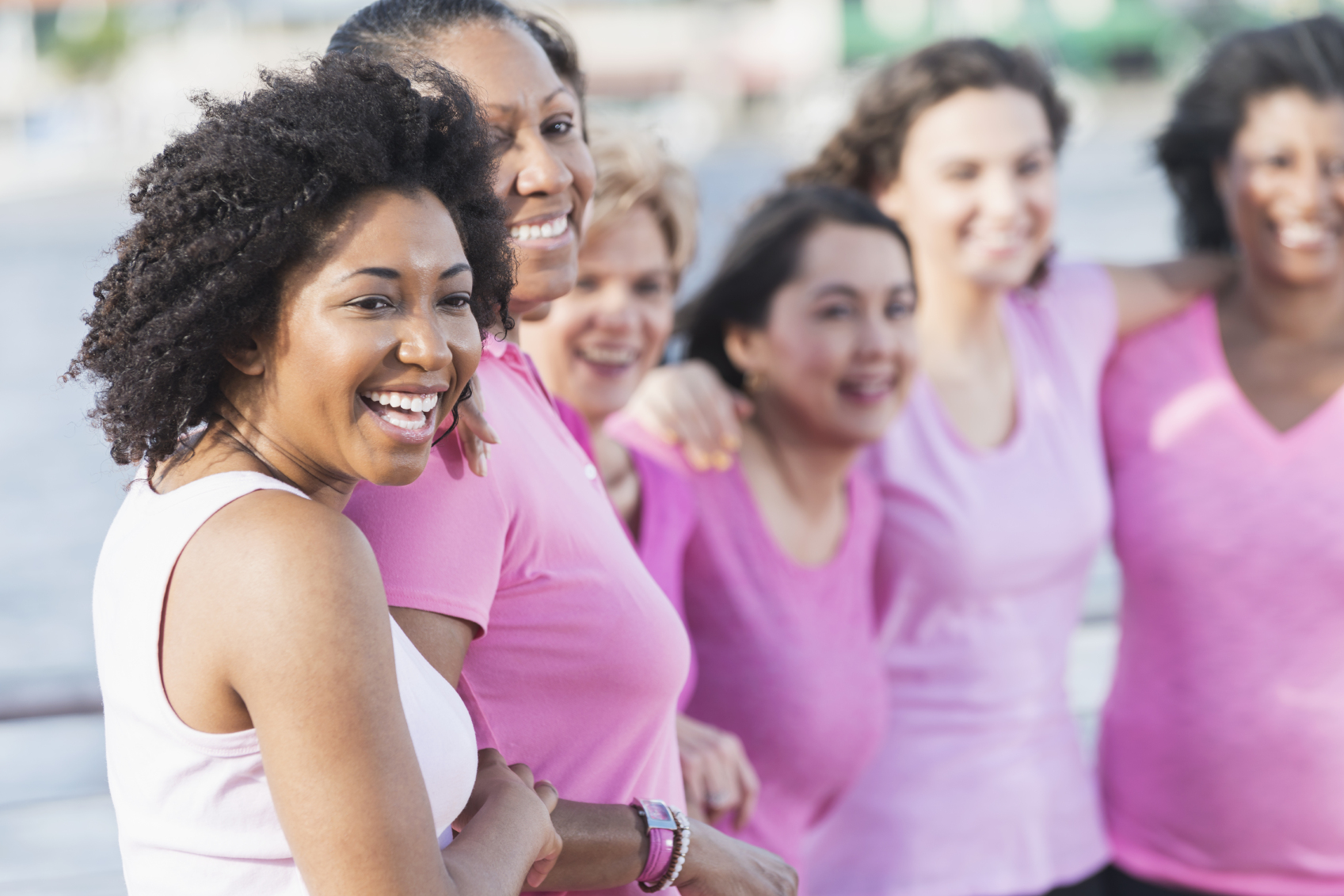 A group of people wearing pink shirts