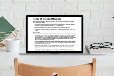 Image of a laptop sitting on a desk with the Notice of Intended Marriage paperwork on the screen