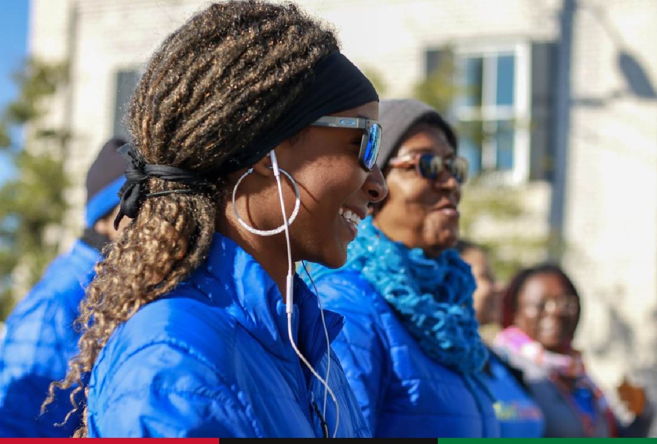A sea of GirlTREK women in superhero blue walking together.