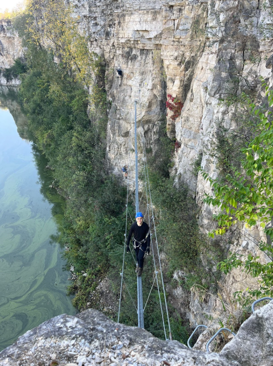 Photo of Gleb standing on a swaying suspension bridge