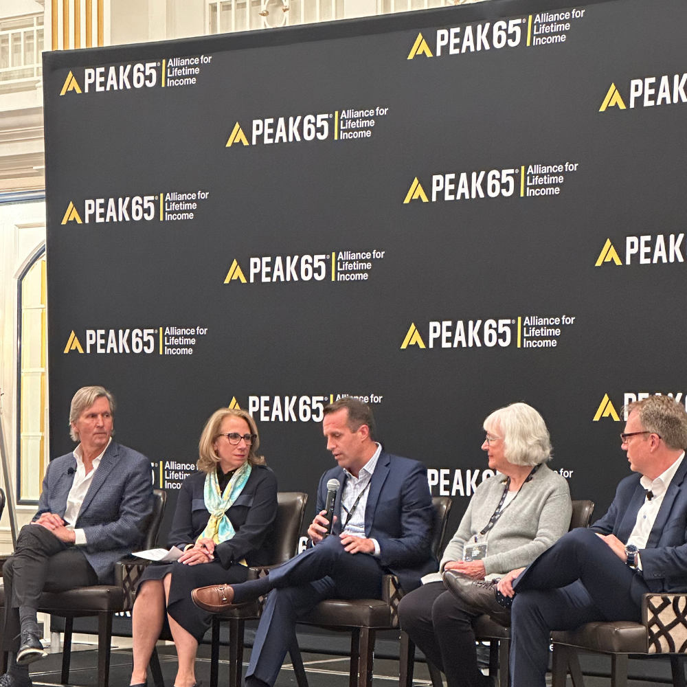 Photo of panelists on stage at the Protected Retirement Summit.