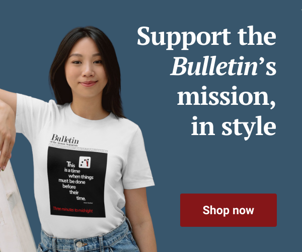 A woman wears a shirt with a Bulletin magazine cover that reads This is a time when things must be done before their time Text reads Support the Bulletins mission in style Shop now