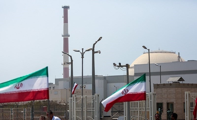 The Bushehr nuclear power plant with its dome-shaped reactor building in the background Iranian flags fly in the foreground
