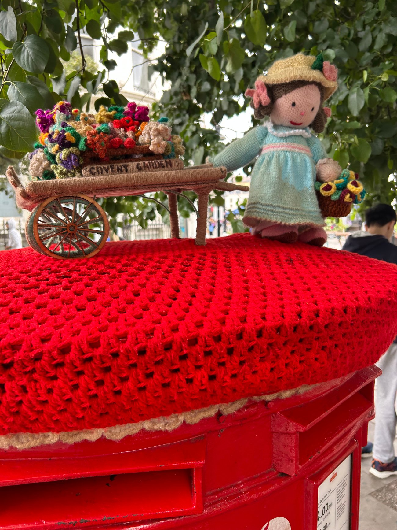 Crocheted post box topper in Covent Garden, London