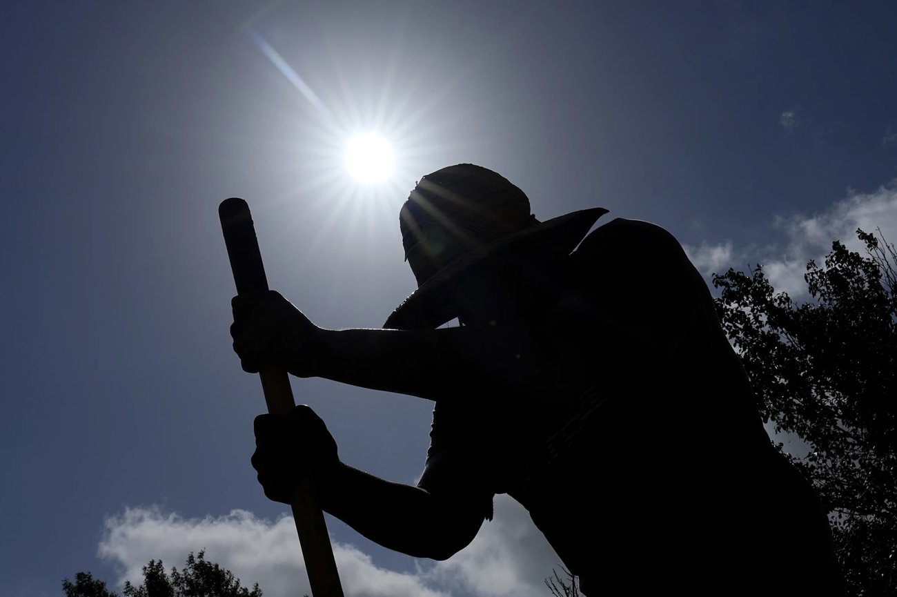 In this file photo, Carlos Rodriguez digs fence post holes on Tuesday, June 27, 2023, in Houston. Outdoor workers are vulnerable to prolonged time in extreme temperatures like those seen across the Gulf South this summer, which climate scientists warn are becoming more common. (AP Photo/David J. Phillip)