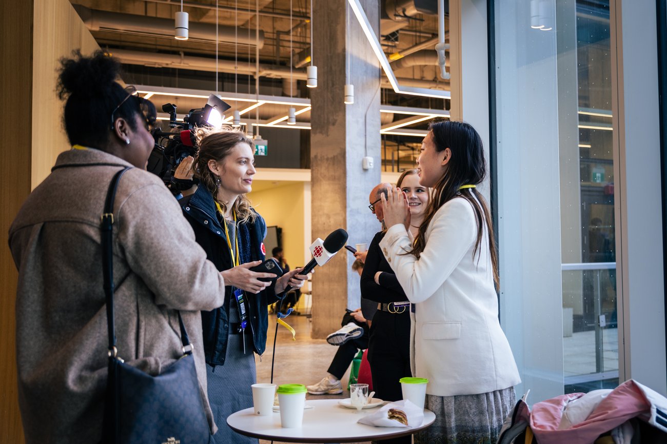 A media crew interviews a young woman 