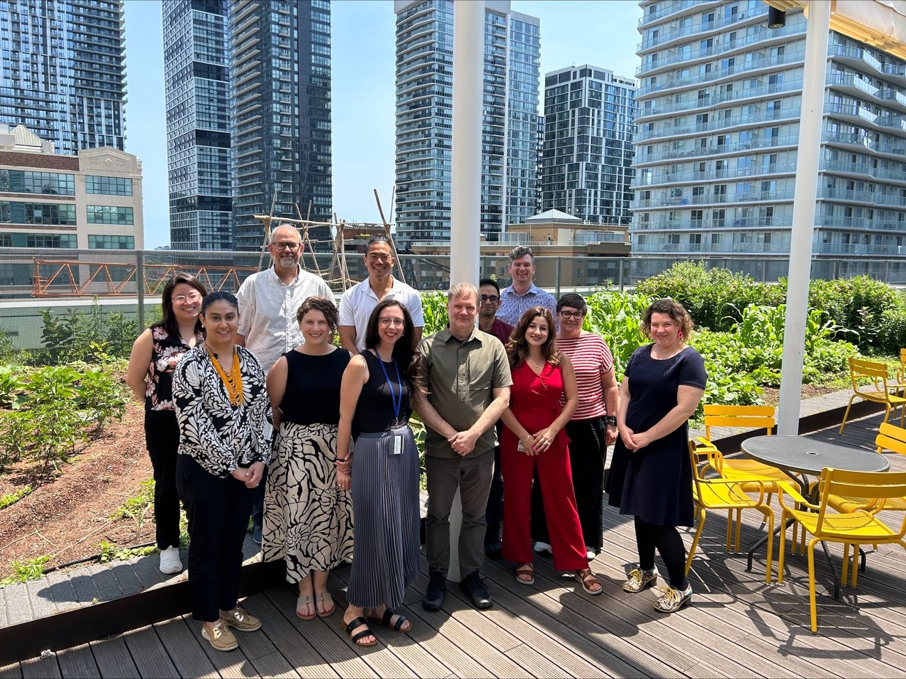 Eleven
attendees of the COED event pose for a group photo by the DCC building's sunny rooftop garden.