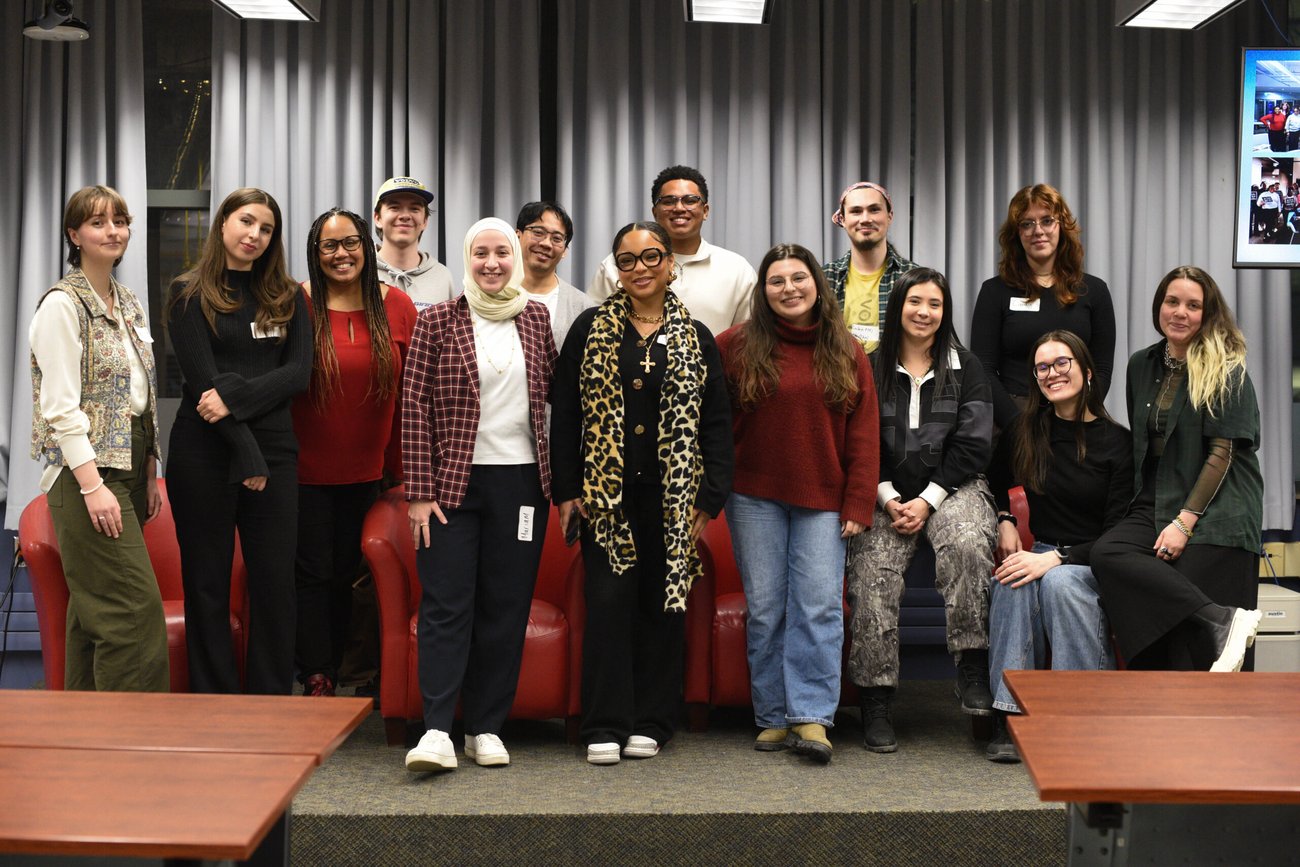 A class of journalism students smiling and and celebrating the new season of the We Met U When podcast at the launch party