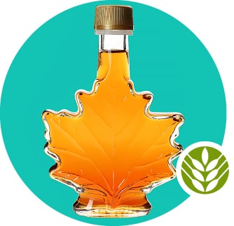 A maple leaf-shaped jar of maple syrup on a turquoise background.