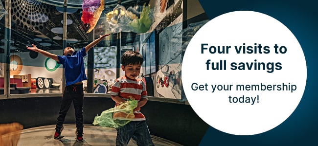 Two children play with colourful pieces of fabric in the wind tunnel at the Canada Science and Technology Museum. In a white circle, text reads "Four visits to full savings. Get your membership today!"