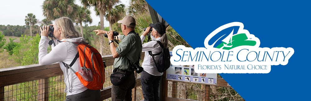 Seminole County Logo with a photo of people biking on the cross seminole trail