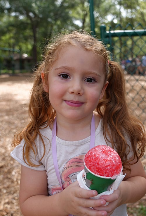 Girl at park enjoying sno-cone