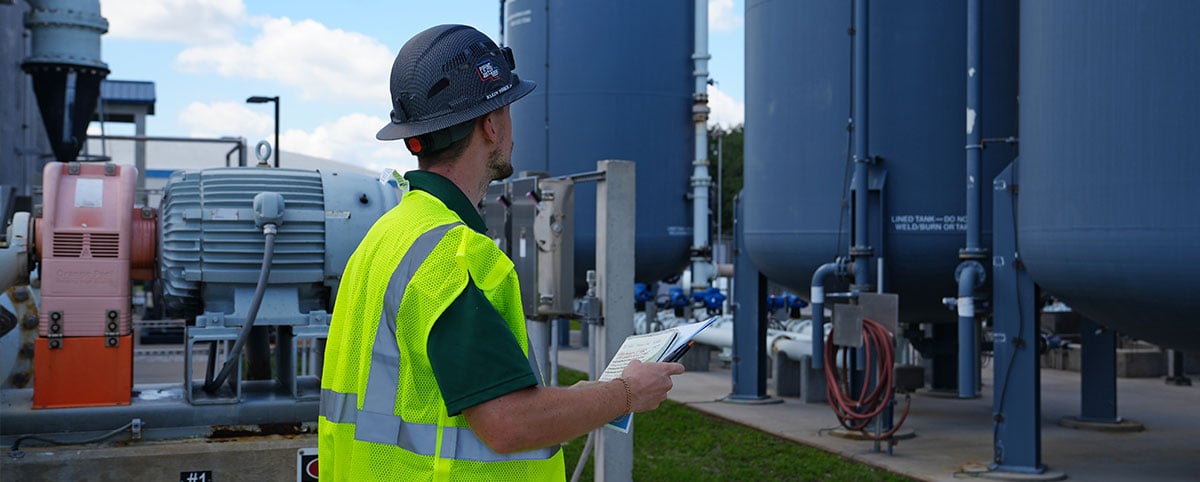 Utility worker inspecting the water treatment plant
