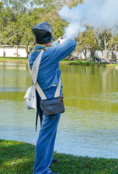 reenactor firing a musket