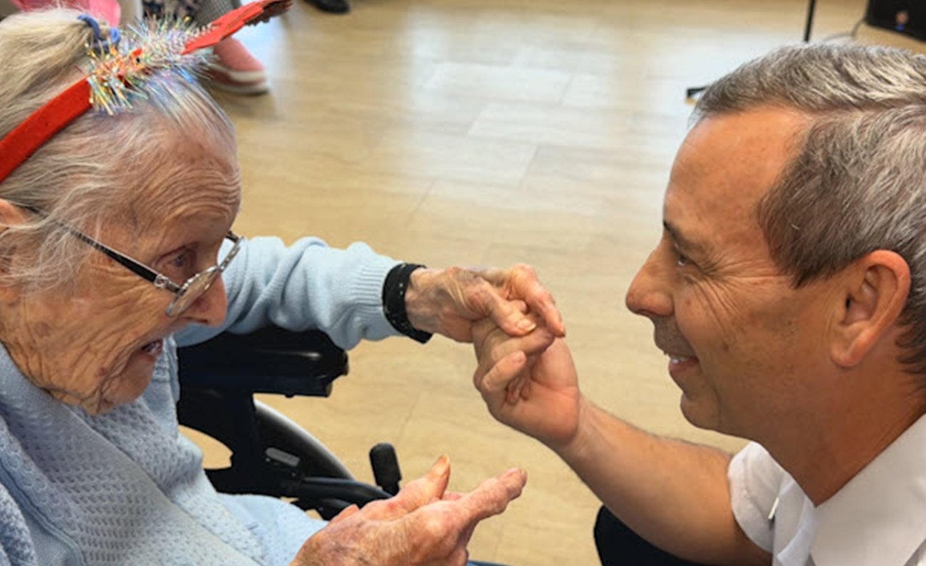 Firefighter with citizen at assisted living facility Firefighter with citizen at assisted living facility