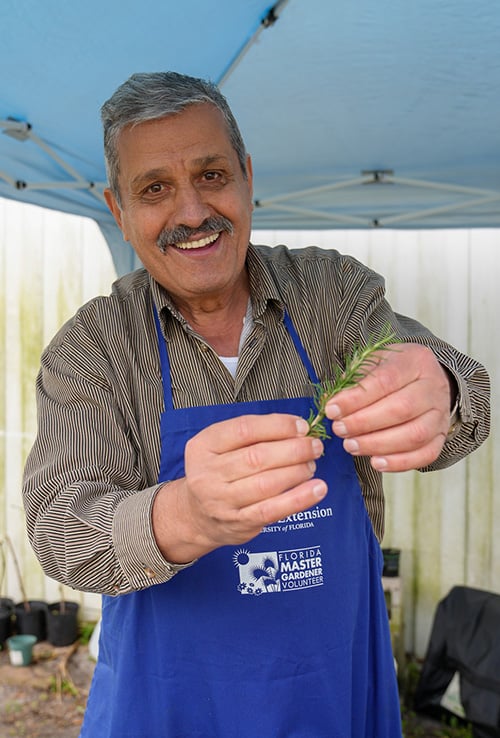 Master gardener holding herb
