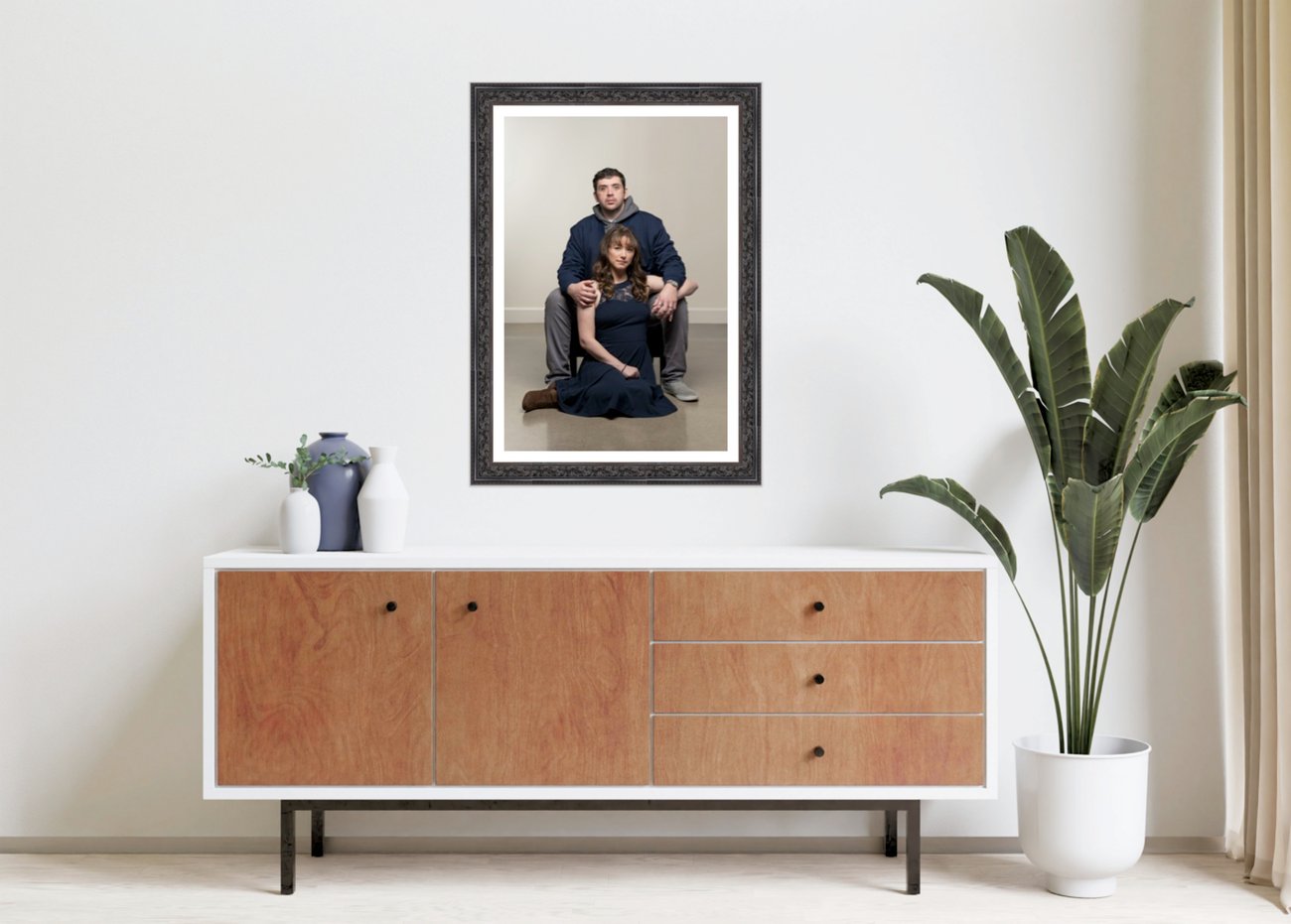 Framed portrait of a couple hanging above a sideboard