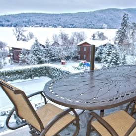 table on deck in winter overlooking lake george