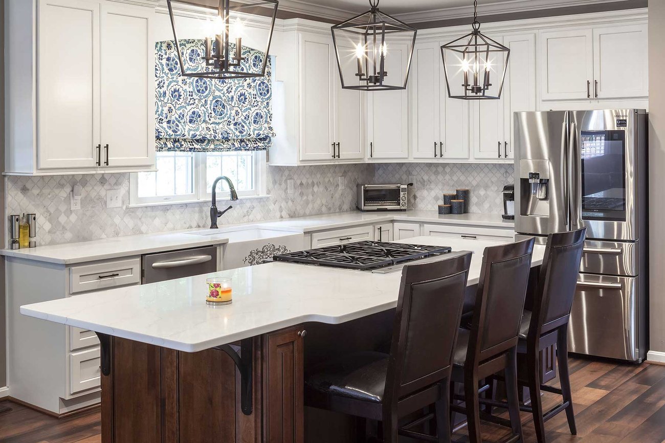 Luxury kitchen remodel with granite topped kitchen island and unique light fixturers