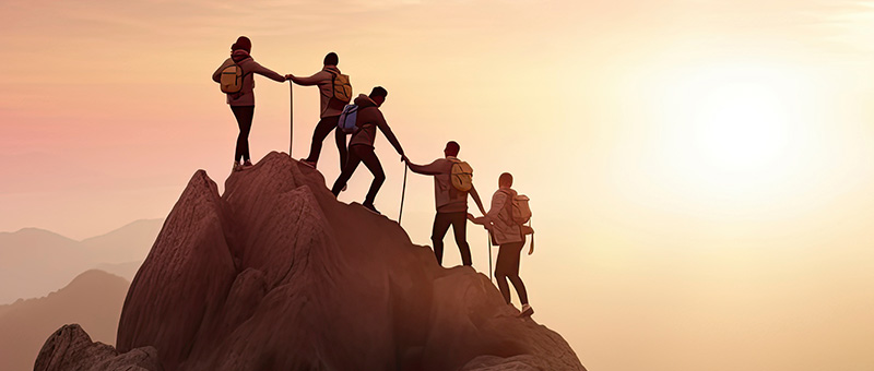 graphic: mountain climbers helping each other