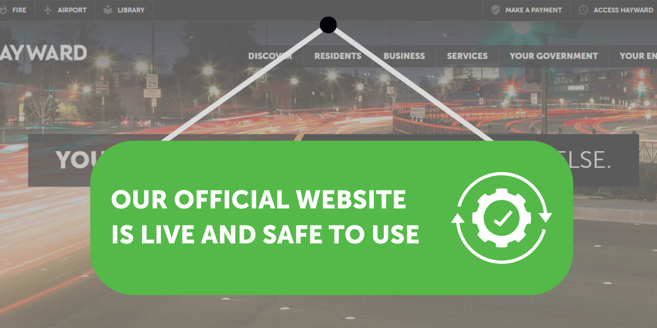 Photo of the City of Hayward website with a sign on top that says "Our official website is live and safe to use"