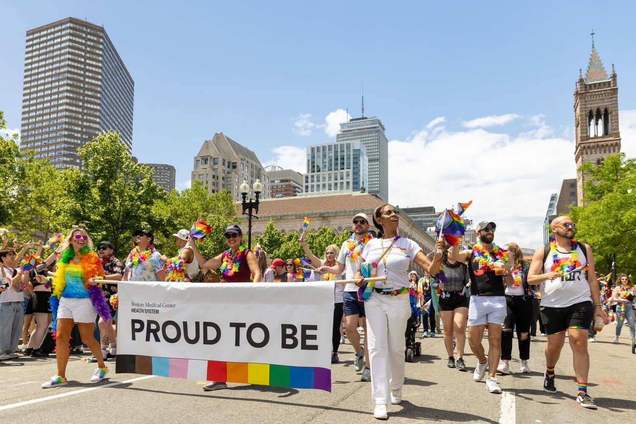 A female radiologist helps a woman get positioned for a mammogram.