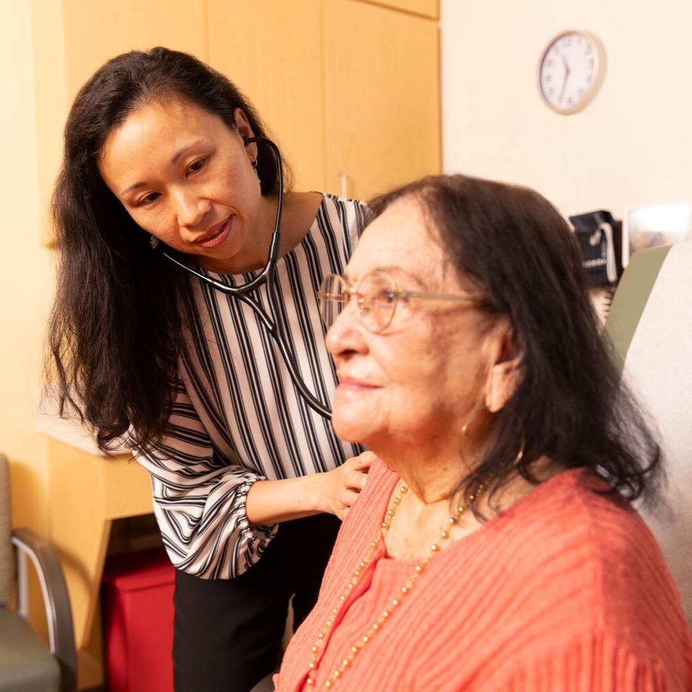A BMC healthcare provider caring for an elderly patient. 