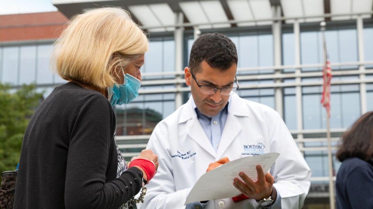 BMC oncologist with patient at campus event 