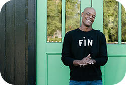 A man wearing a FiN black Claire V sweatshirt.