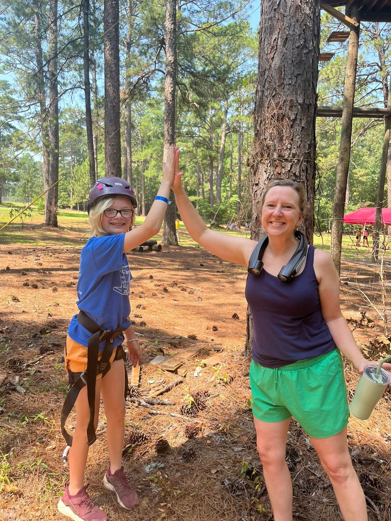 Image of a young girl giving 4-H Agent a high five