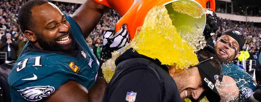 The Philadelphia Eagles head coach, Nick Sirianni, is doused by defensive tackle Fletcher Cox and teammates after the NFC Championship game January 29, 2023.
