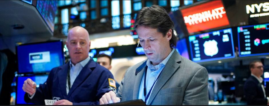 Traders work on the floor at the New York Stock Exchange Wednesday.