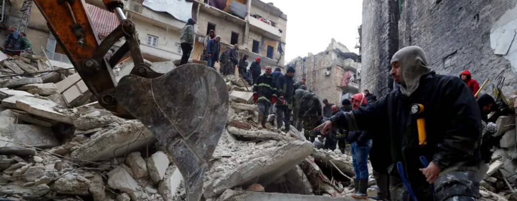 Syrian Civil Defense workers and security forces search through the wreckage of collapsed buildings at Aleppo, February 6, 2023.