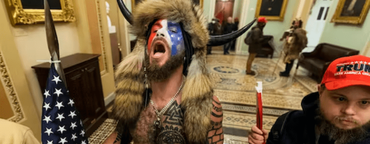Jacob Chansley, center, with other insurrectionists who supported then-President Donald Trump, are confronted by U.S. Capitol Police in the hallway outside of the Senate chamber in the Capitol, Jan. 6, 2021, at Washington. AP /Manuel Balce Ceneta