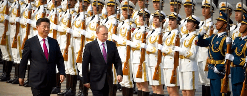 Presidents Xi and Putin review an honor guard during a welcoming ceremony at the Great Hall of the People at Beijing. AP/Mark Schiefelbein, file