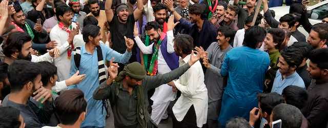 Supporters of Imran Khan dance outside of his house at Lahore, Pakistan, March 19, 2023. Police in the Pakistani capital filed charges Sunday against former prime minister and 17 of his aides and scores of supporters. AP/K.M. Chaudary