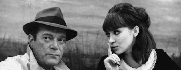 Eddie Constantine and Anna Karina in 'Alphaville,' 1965. Via Photofest