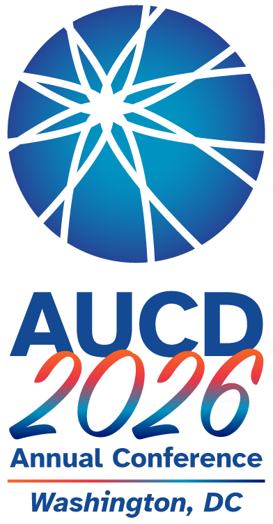 The AUCD 2026 Annual Conference logo features a blue circular graphic with white intersecting lines forming a starburst pattern above the text “AUCD 2026.” Below, the words “Annual Conference” appear in blue, followed by “Washington, DC.” The design uses blue and orange gradient accents on a white background.