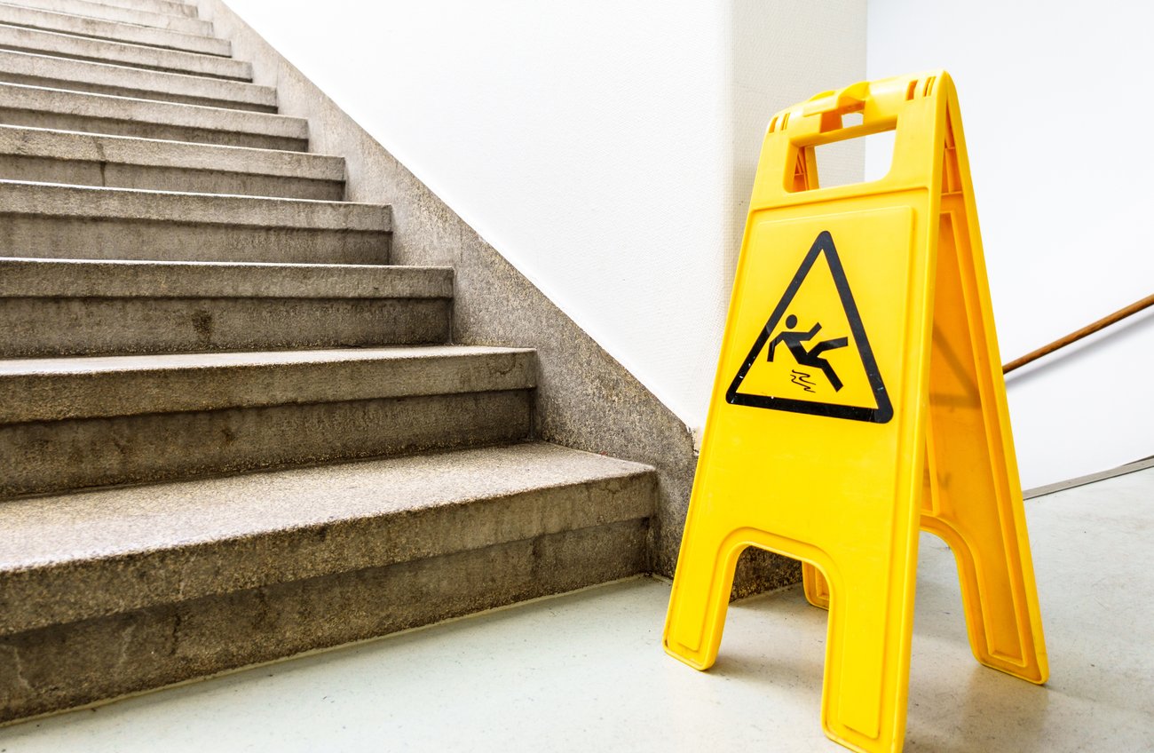 wet floor sign next to a staircase