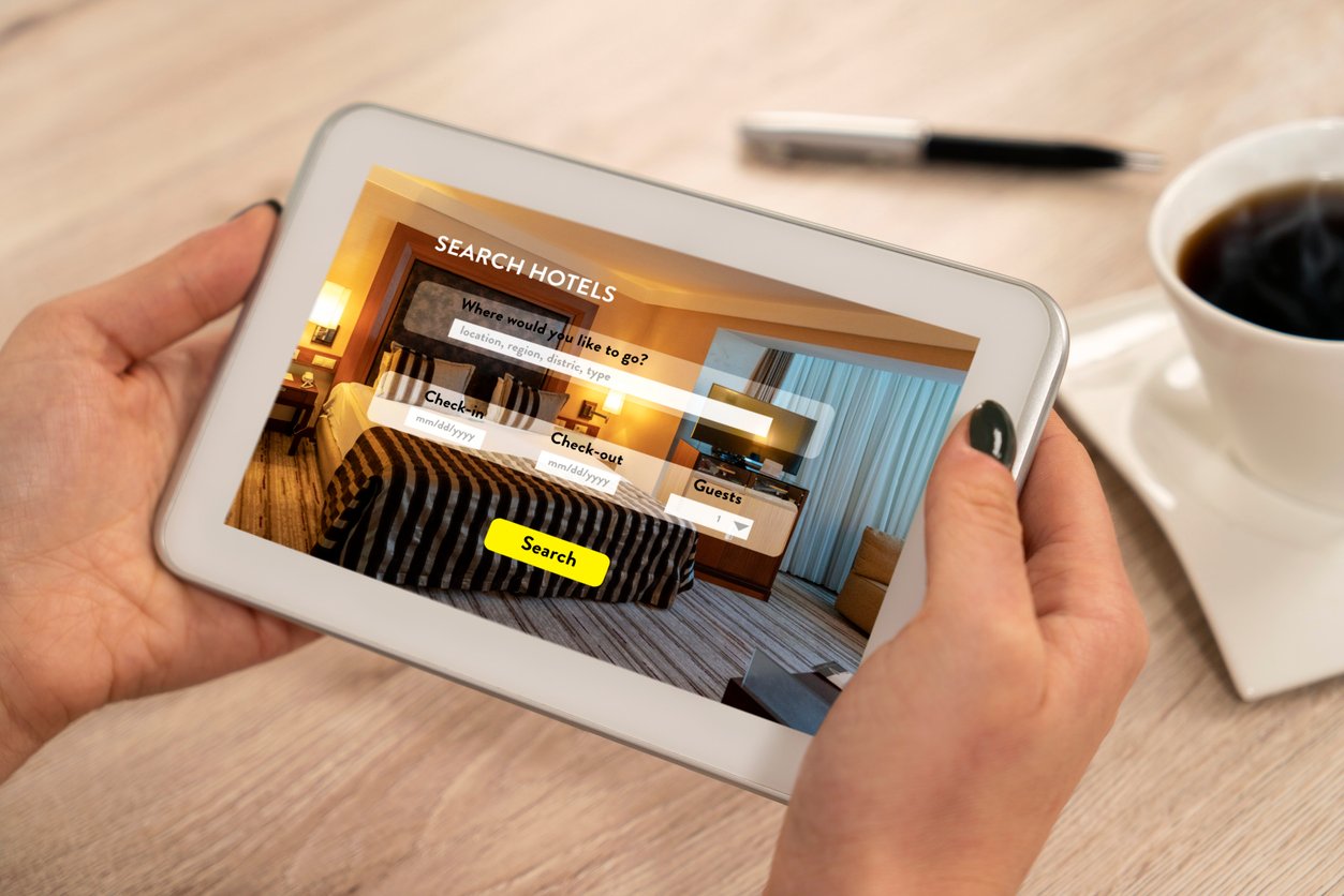 Woman accessing a hotel website from a tablet.