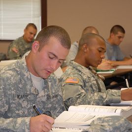 Soldier sitting at a desk in a classroom