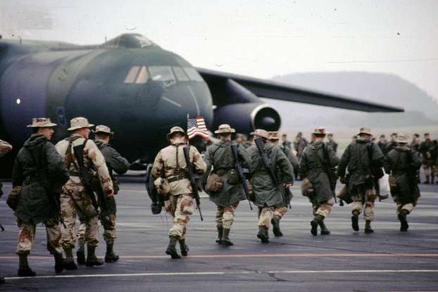 Soldiers deploying to the Gulf War make their way to a plane in 1990 at Volk Field, Wis.