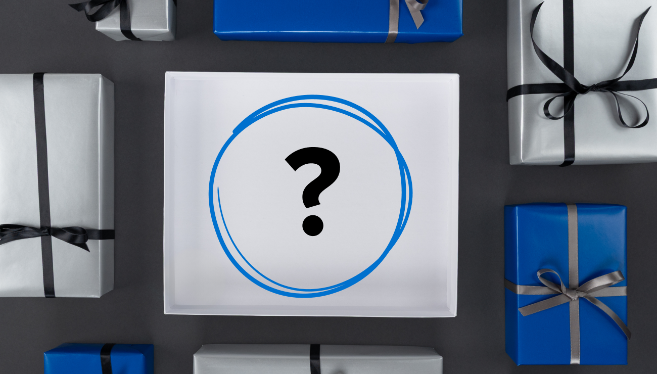 A white gift box with a large blue scribble circle with black question mark inside sits centered among neatly wrapped presents in iFixit blue and silver, each tied with black or silver ribbons. The composition hints at a quiz theme in a clean, modern holiday style.