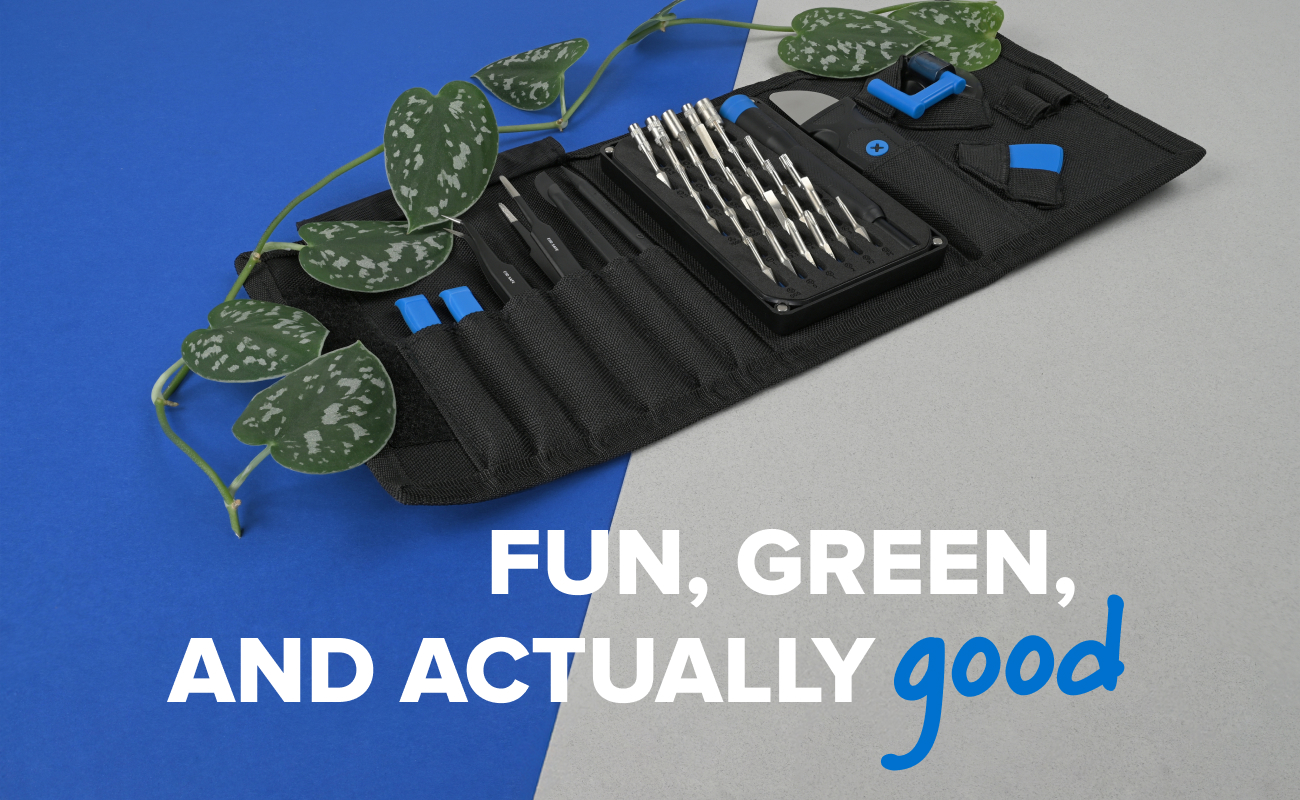 The iFixit Pro Tech Go toolkit opened on a split blue and gray background, with a green vine draped across the neatly arranged tools and bits. White and blue text reading “FUN, GREEN, AND ACTUALLY good” reinforces the sustainable, repair-positive theme.
