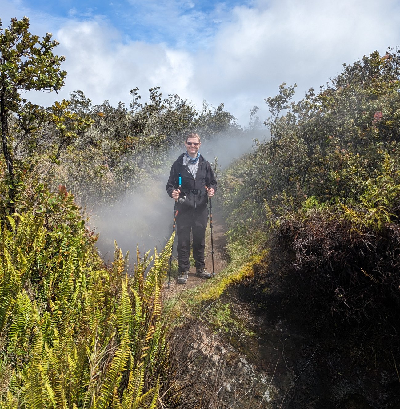 photo of Dr. Gleb at Hawaii Volcanoes National Park standing at a steam vent near the Kilauea volcano