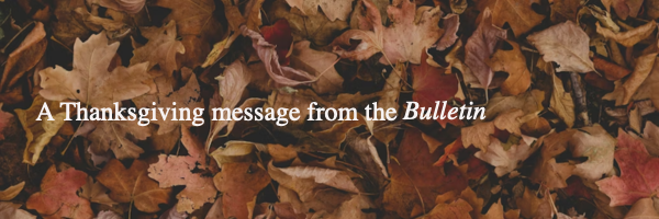 White text says A Thanksgiving message from the Bulletin over a close up of a pile of leaves in various shades of red yellow orange and brown
