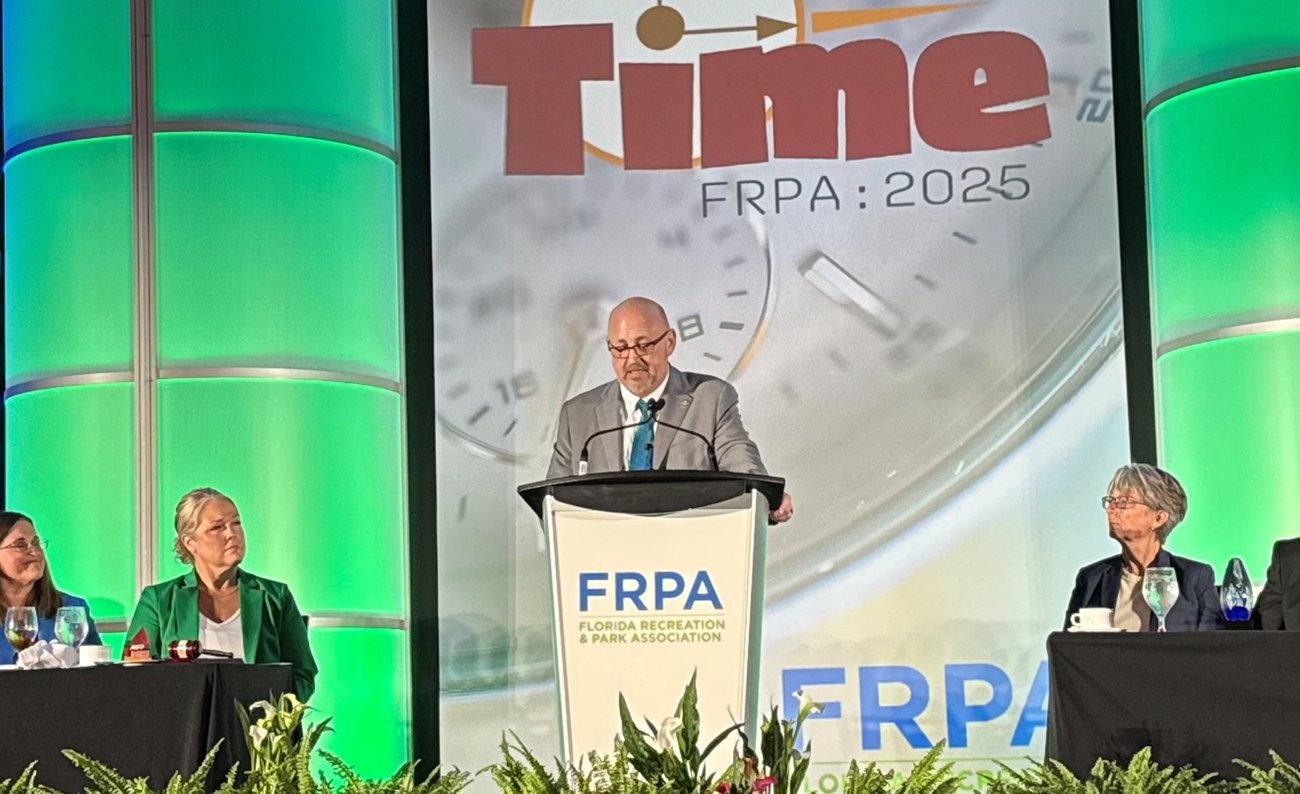 Recreation Director Richard Durr standing at podium of FRPA event.