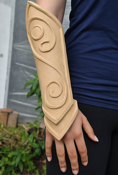 close-up of a person modeling a custom worbla bracer on arm.