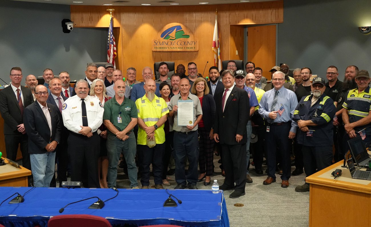 board members and veterans standing with proclamation at the Board of county commissioners meeting
